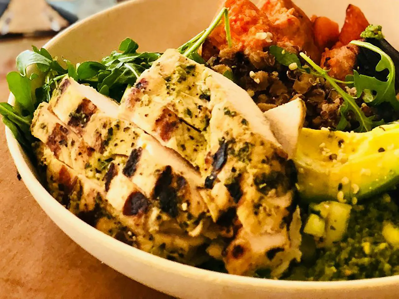 Grilled herb chicken with quinoa, avocado and sweet potato in a bowl