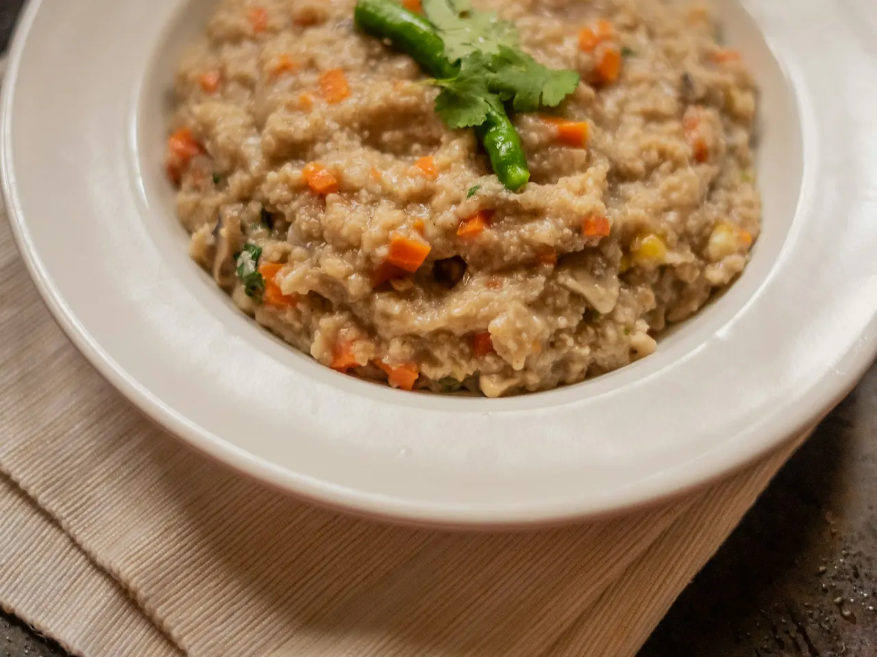 Savoury masala oats with vegetables and a coriander garnish