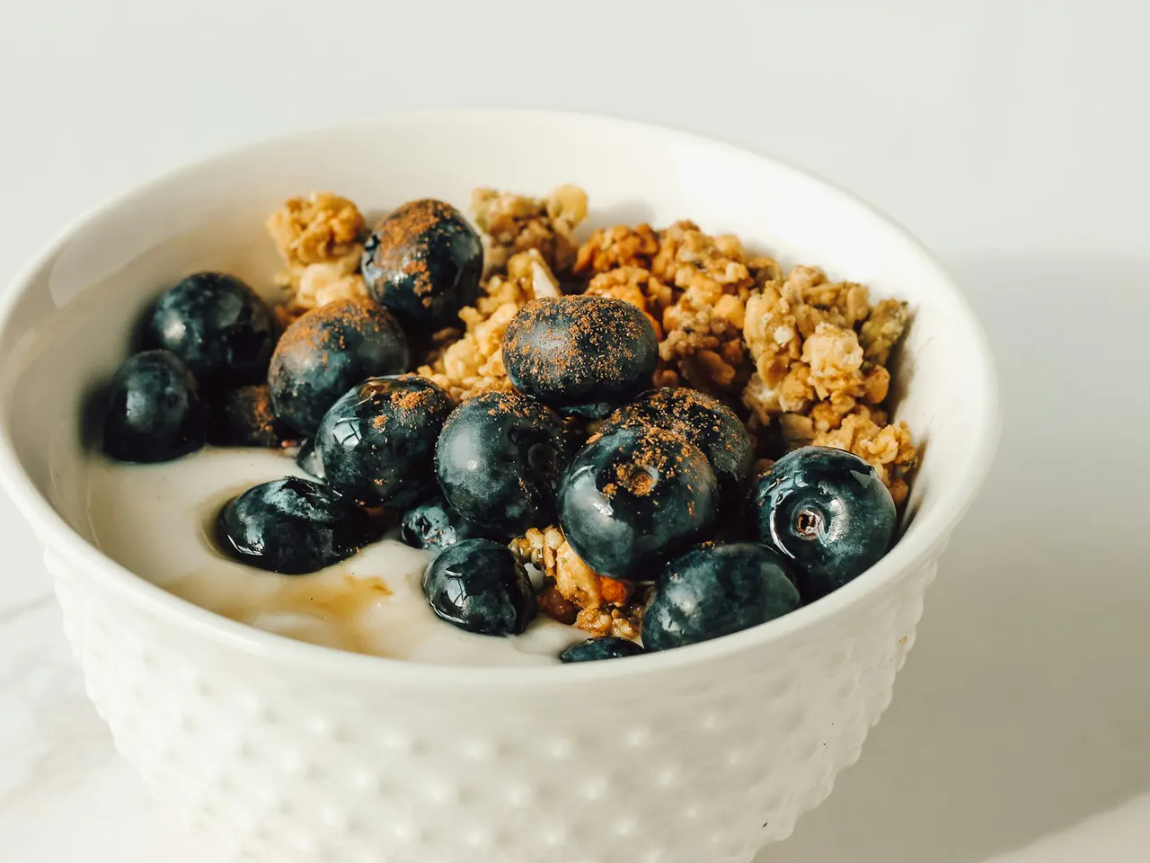 Greek yogurt bowl topped with blueberries, berries and granola